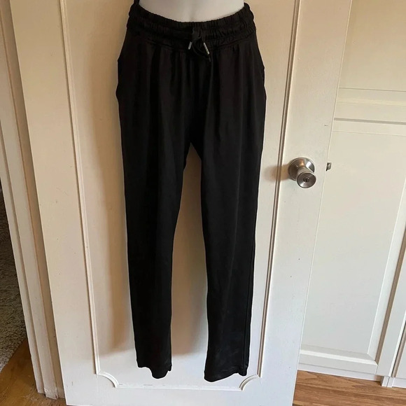 Lululemon black joggers with drawstring elastic waist band, and hemline.  Size 4 - Picture 1 of 13